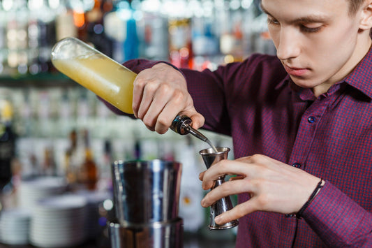 The bartender making cocktail