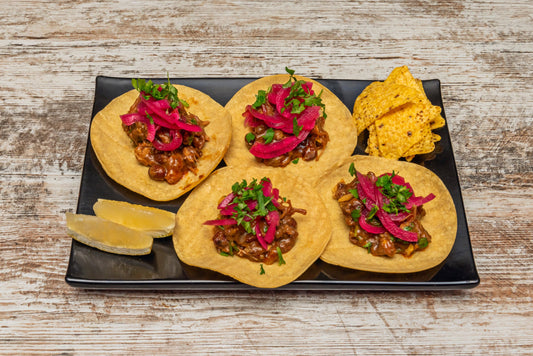 Tacos de Barbacoa**: Traditionally made with lamb or beef, steamed in maguey leaves, with a dash of Mezcal