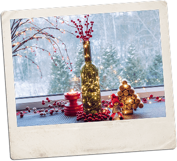Bottle with fairy lights and winter decorations