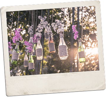 Hanging bottle vases with flowers